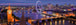 Diamond Painting der Londoner Skyline mit dem London Eye und Brücken bei Nacht in Blau- und Violetttönen. 
